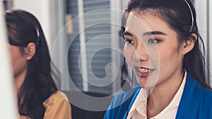 Businesswoman wearing headset working actively in office