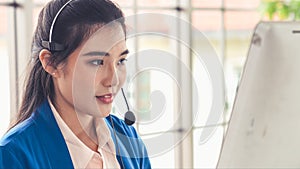 Businesswoman wearing headset working actively in office