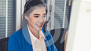 Businesswoman wearing headset working actively in office