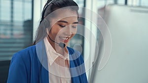 Businesswoman wearing headset working actively in office