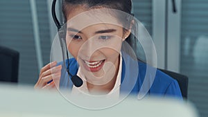 Businesswoman wearing headset working actively in office