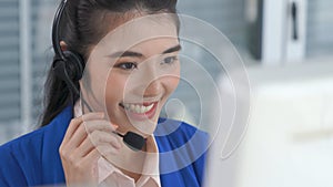 Businesswoman wearing headset working actively in office