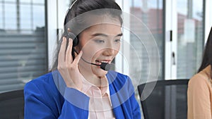 Businesswoman wearing headset working actively in office