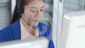 Businesswoman wearing headset working actively in office