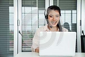 Businesswoman wearing headset working actively in office