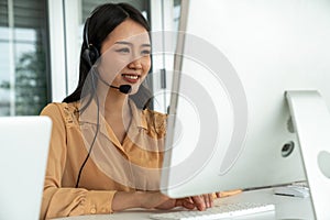 Businesswoman wearing headset working actively in office