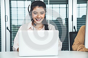 Businesswoman wearing headset working actively in office