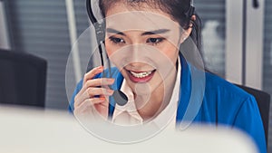 Businesswoman wearing headset working actively in office