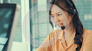 Businesswoman wearing headset working actively in office