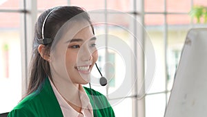 Businesswoman wearing headset working actively in office