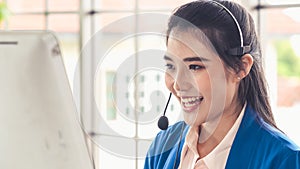 Businesswoman wearing headset working actively in office