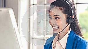 Businesswoman wearing headset working actively in office