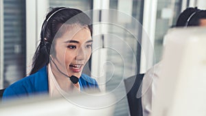 Businesswoman wearing headset working actively in office