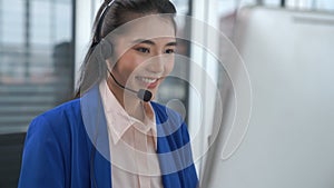 Businesswoman wearing headset working actively in office