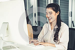 Businesswoman wearing headset working actively in office