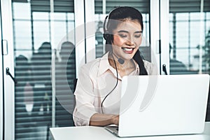 Businesswoman wearing headset working actively in office