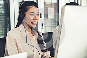 Businesswoman wearing headset working actively in office