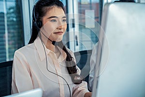 Businesswoman wearing headset working actively in office