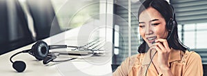 Businesswoman wearing headset working actively in office