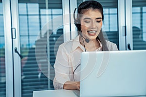 Businesswoman wearing headset working actively in office