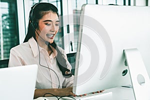 Businesswoman wearing headset working actively in office