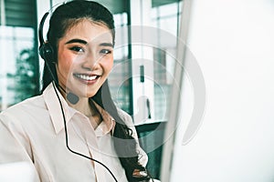 Businesswoman wearing headset working actively in office