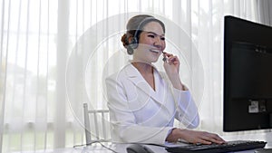 Businesswoman wearing headset working in vivancy office