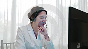 Businesswoman wearing headset working in vivancy office