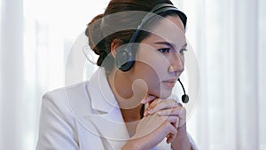 Businesswoman wearing headset working in vivancy office