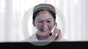 Businesswoman wearing headset working in vivancy office