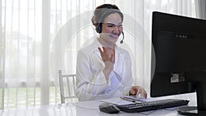 Businesswoman wearing headset working in vivancy office