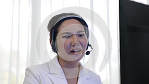 Businesswoman wearing headset working in vivancy office