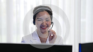 Businesswoman wearing headset working in vivancy office