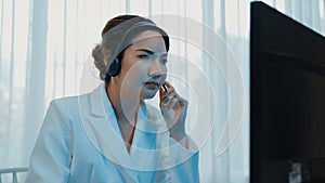 Businesswoman wearing headset working in vivancy office