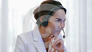 Businesswoman wearing headset working in vivancy office