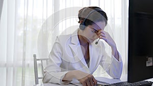 Businesswoman wearing headset working in vivancy office