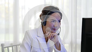 Businesswoman wearing headset working in vivancy office