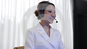 Businesswoman wearing headset working in vivancy office