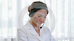 Businesswoman wearing headset working in vivancy office