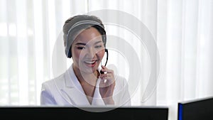 Businesswoman wearing headset working in vivancy office