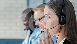 Businesswoman wearing microphone headset using computer in the office - operator, call center