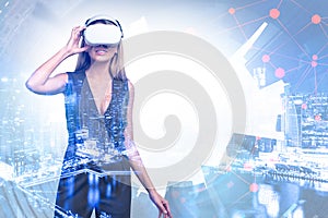 Businesswoman wearing vr glasses, skyscrapers and network connection