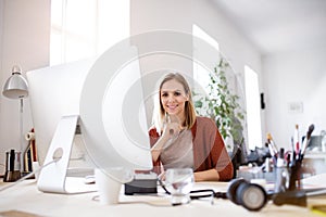 Businesswoman in wheelchair at the desk in her office.