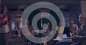 Businesswoman in wheelchair having business meeting with team at modern office