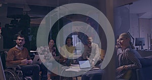 Businesswoman in wheelchair having business meeting with team at modern office