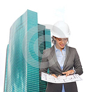 Businesswoman in white helmet with blueprint
