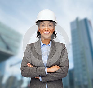 Businesswoman in white helmet with crossed arms