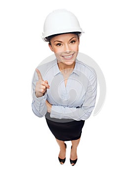 Businesswoman in white helmet with finger up
