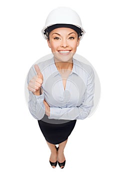 Businesswoman in white helmet showing thumbs up