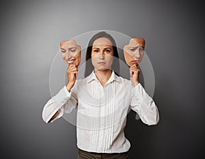 Businesswoman woman holding two masks